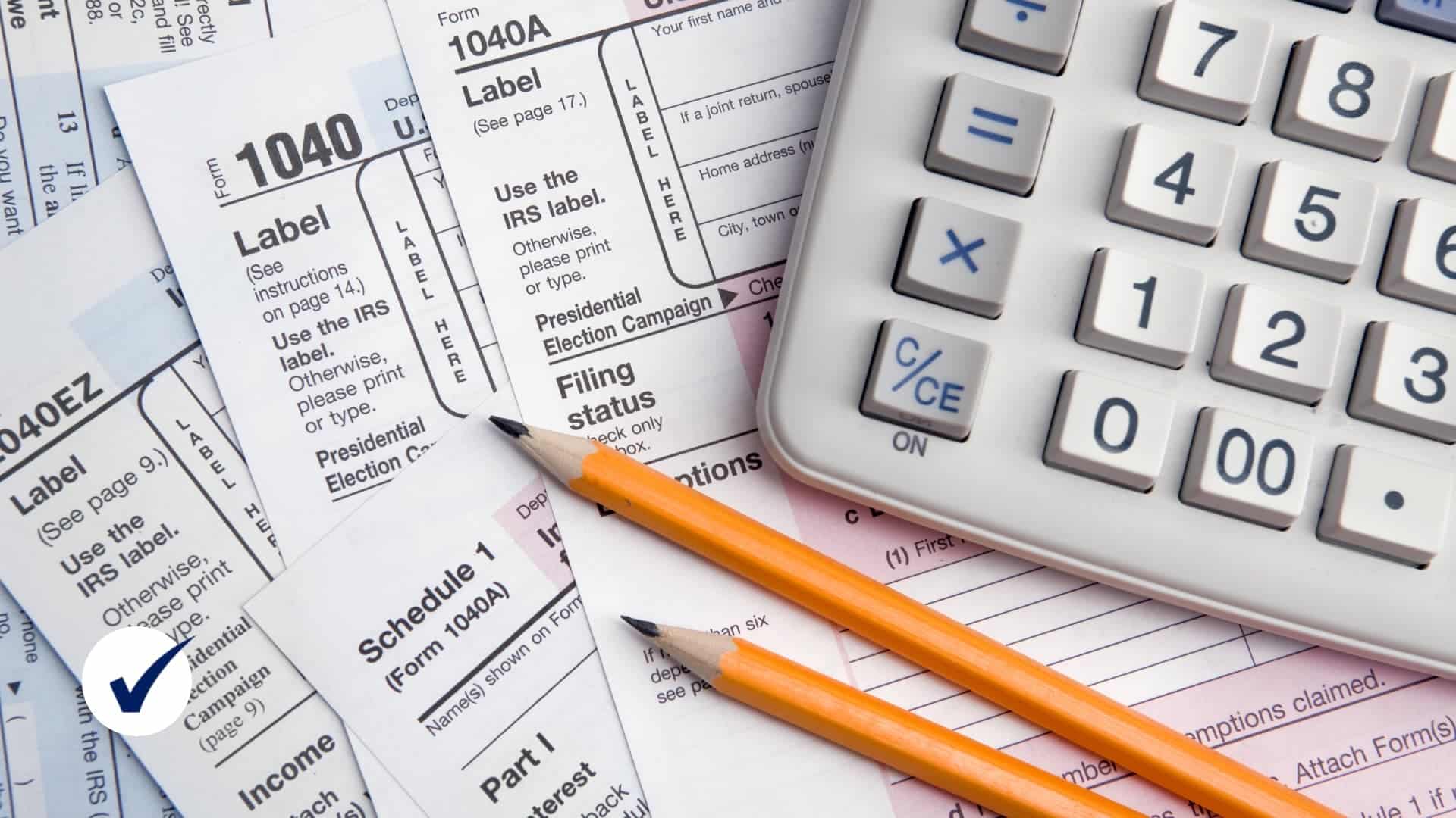 Tax prep forms with pencils and calculator